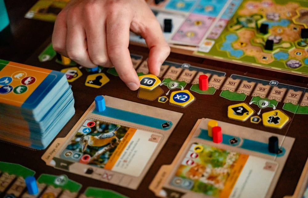 Animal, sponsor, and conservation cards fanned out, each carrying its own special ability.