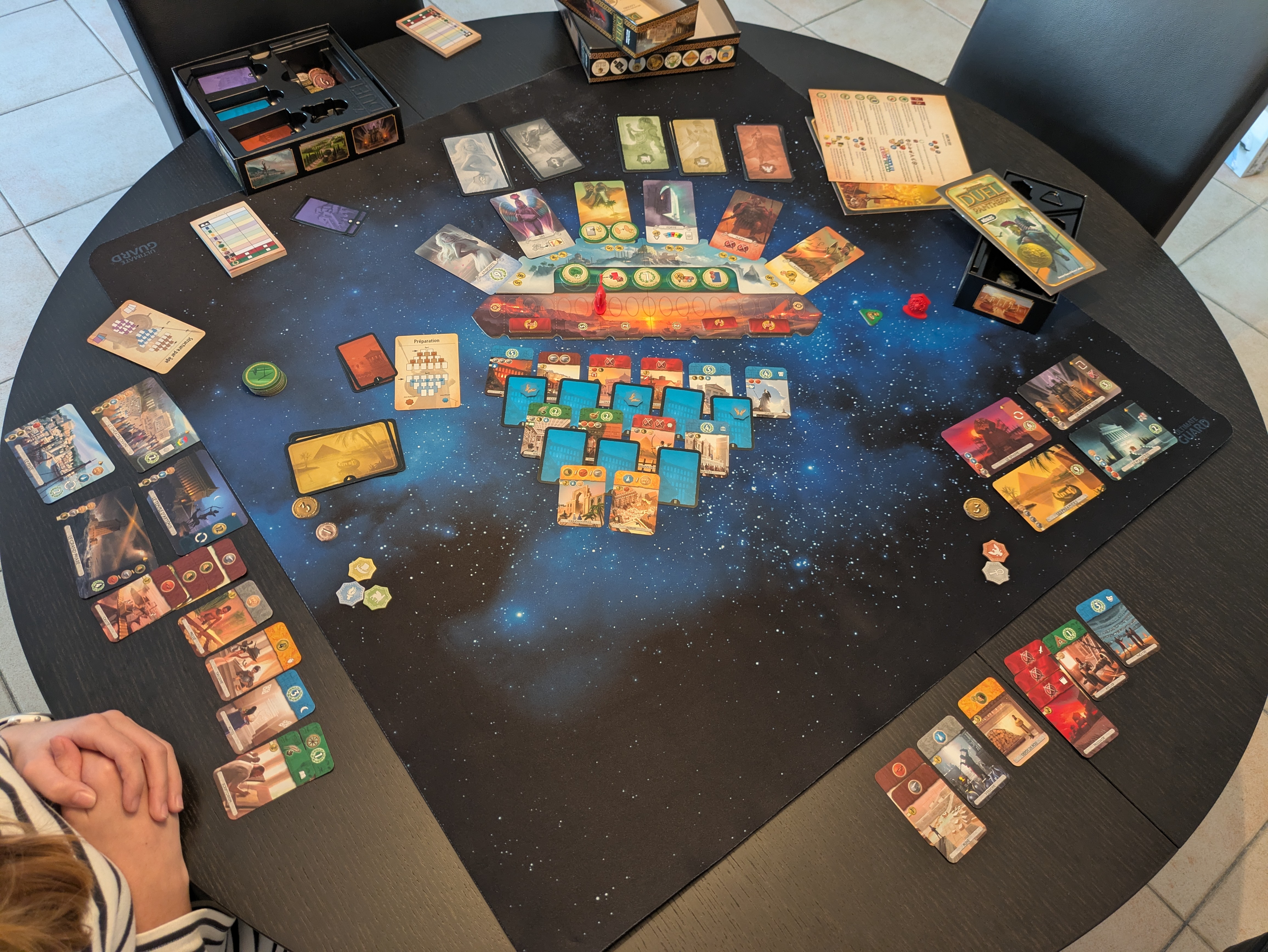 Two players facing off across a board game