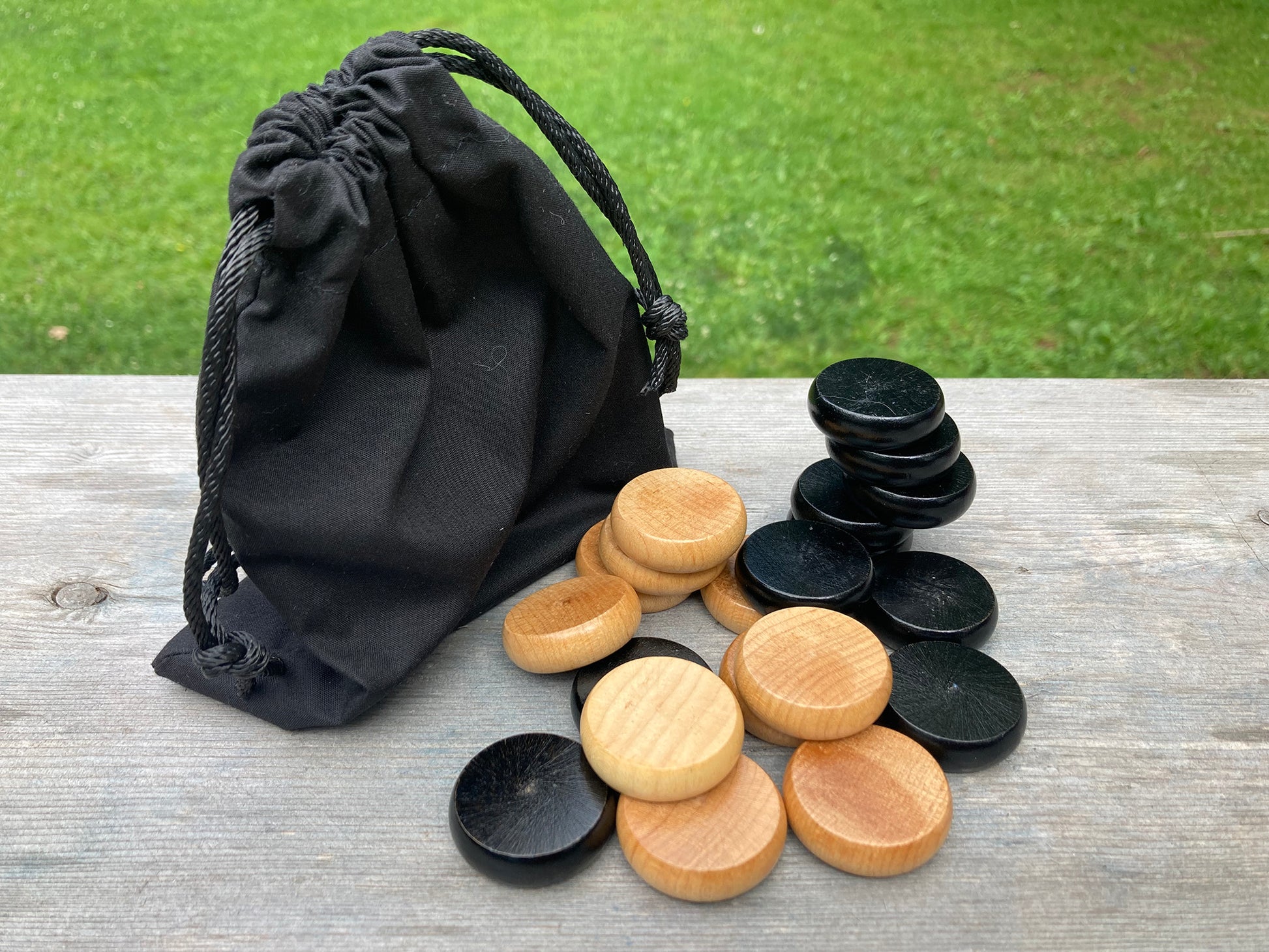 Crokinole discs and checkers with storage pouch