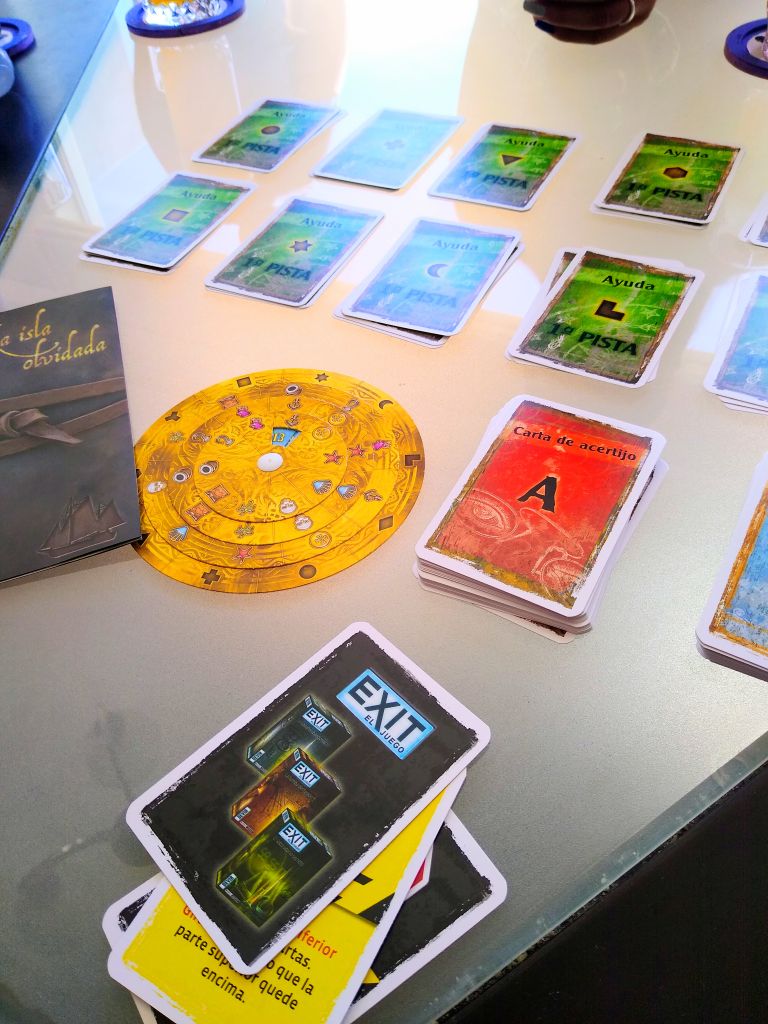 Friends gathered around a table racing through EXIT: The Forgotten Island