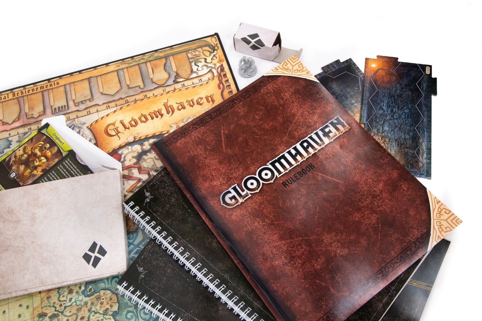 Gloomhaven components laid out: map tiles, miniatures, enemy standees, and decks ready for a campaign session.