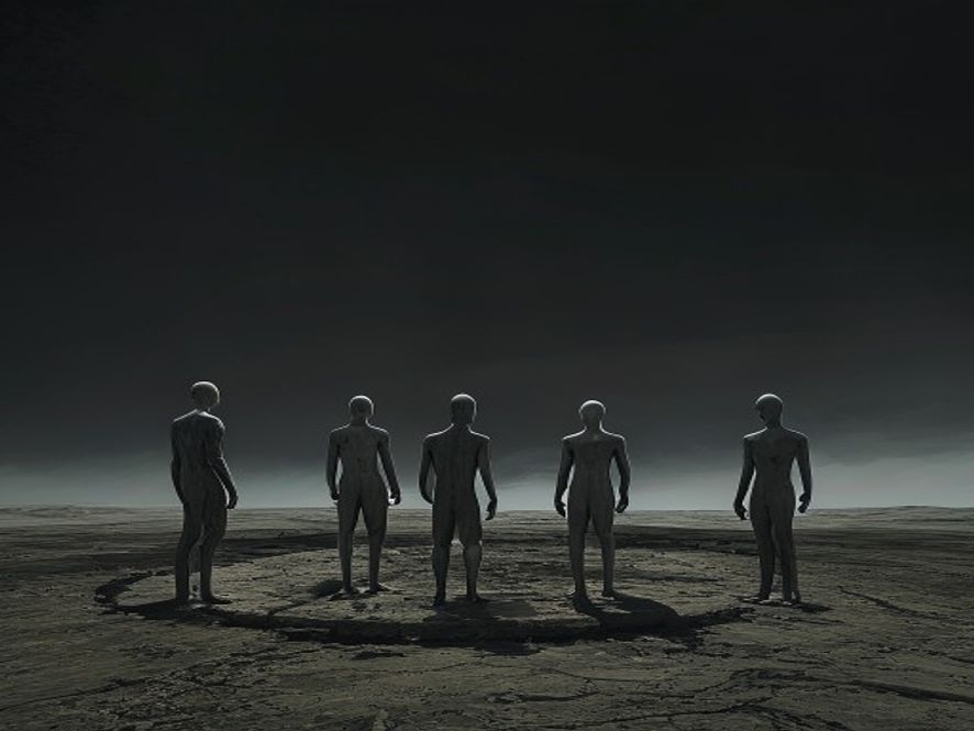 Four blank humanoid figures standing in a circle on a barren stone plain under a black sky.